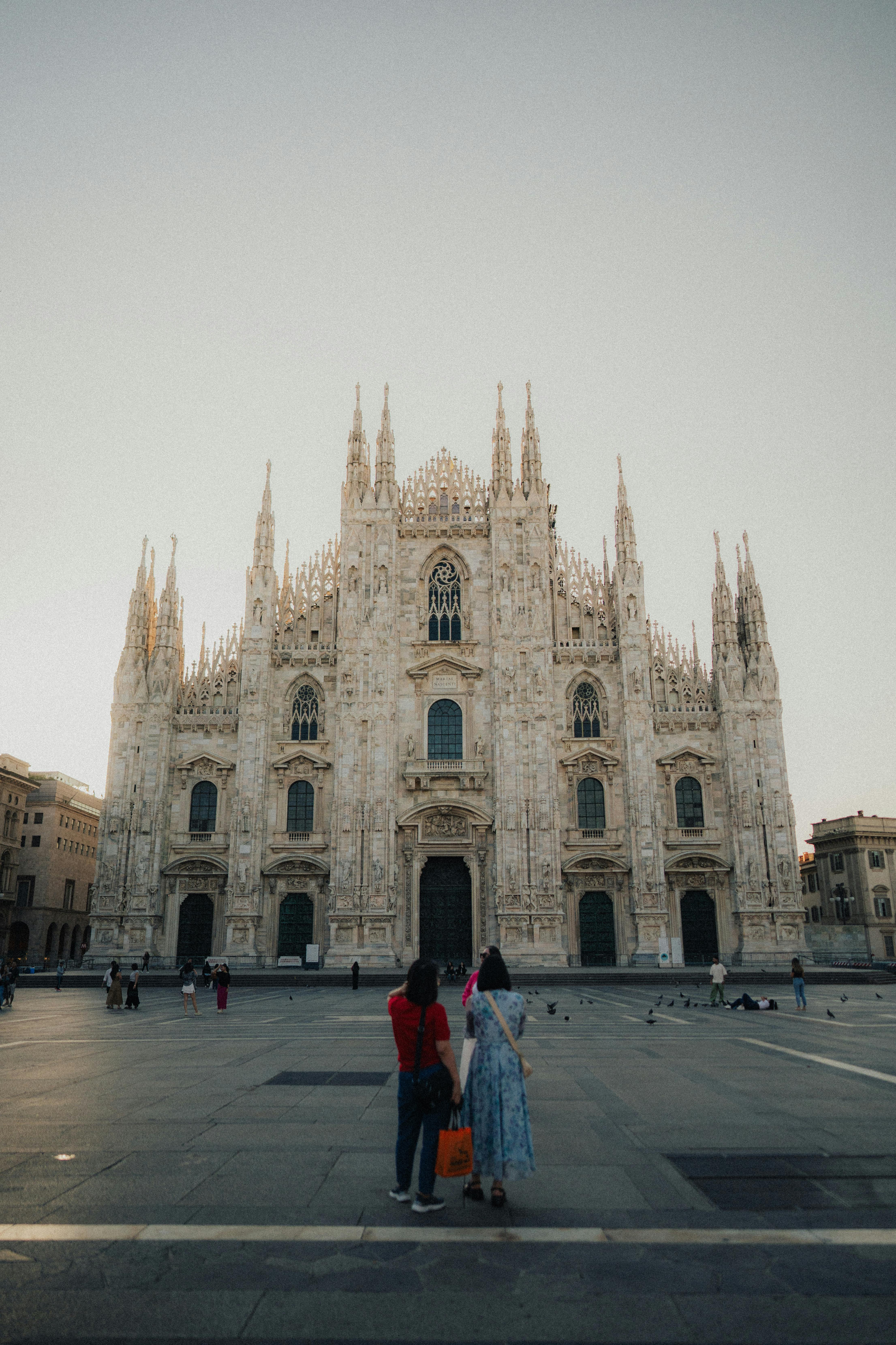 Free A Few Tourists Standing in Front of the Milan Cathedral in Milan, Lombardy, Italy  Stock Photo
