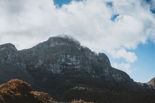 Free A stunning view of a mountain peak covered in clouds, showcasing nature's beauty. Stock Photo