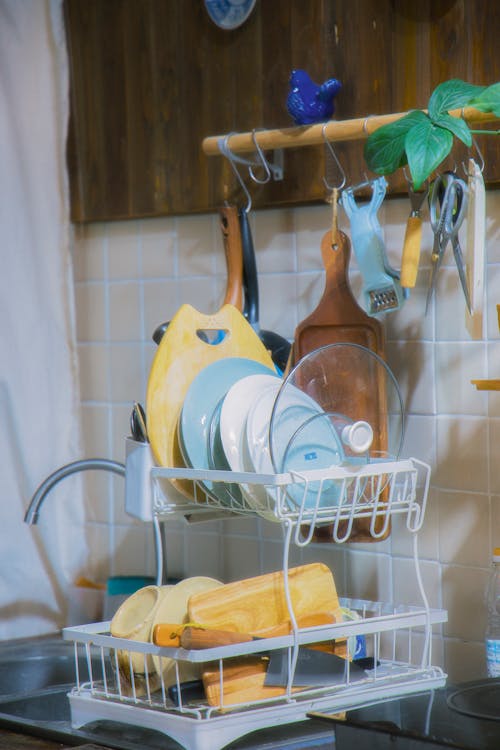 Free A dish rack with dishes and utensils hanging from it Stock Photo