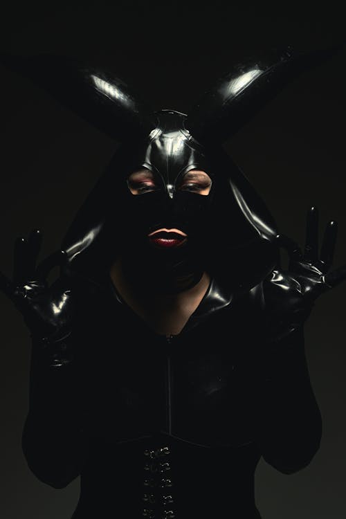 A woman in black latex with bunny ears