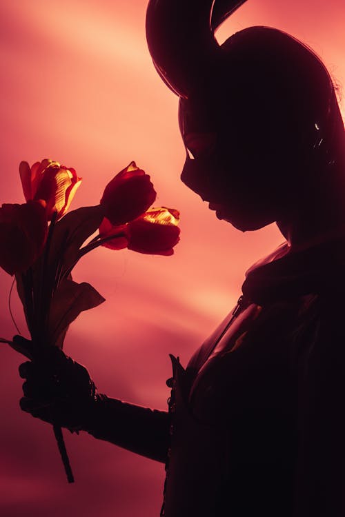 A woman in a bunny costume holding a bunch of flowers