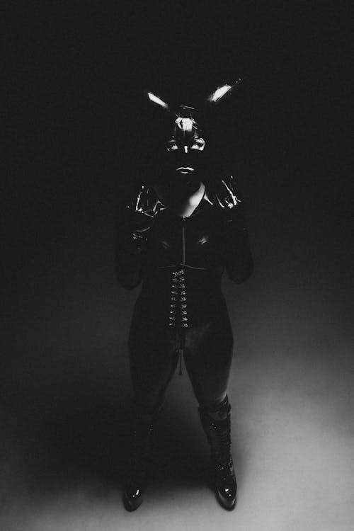 A black and white photo of a woman in latex