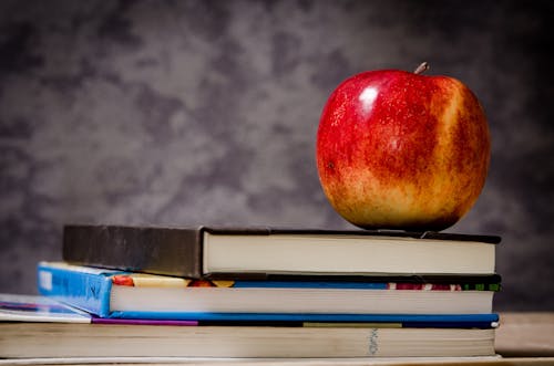 Close-up of Apple on Top of Books