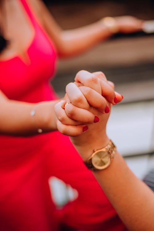 A woman holding the hand of another woman