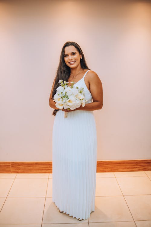 A bride in a white dress holding a bouquet