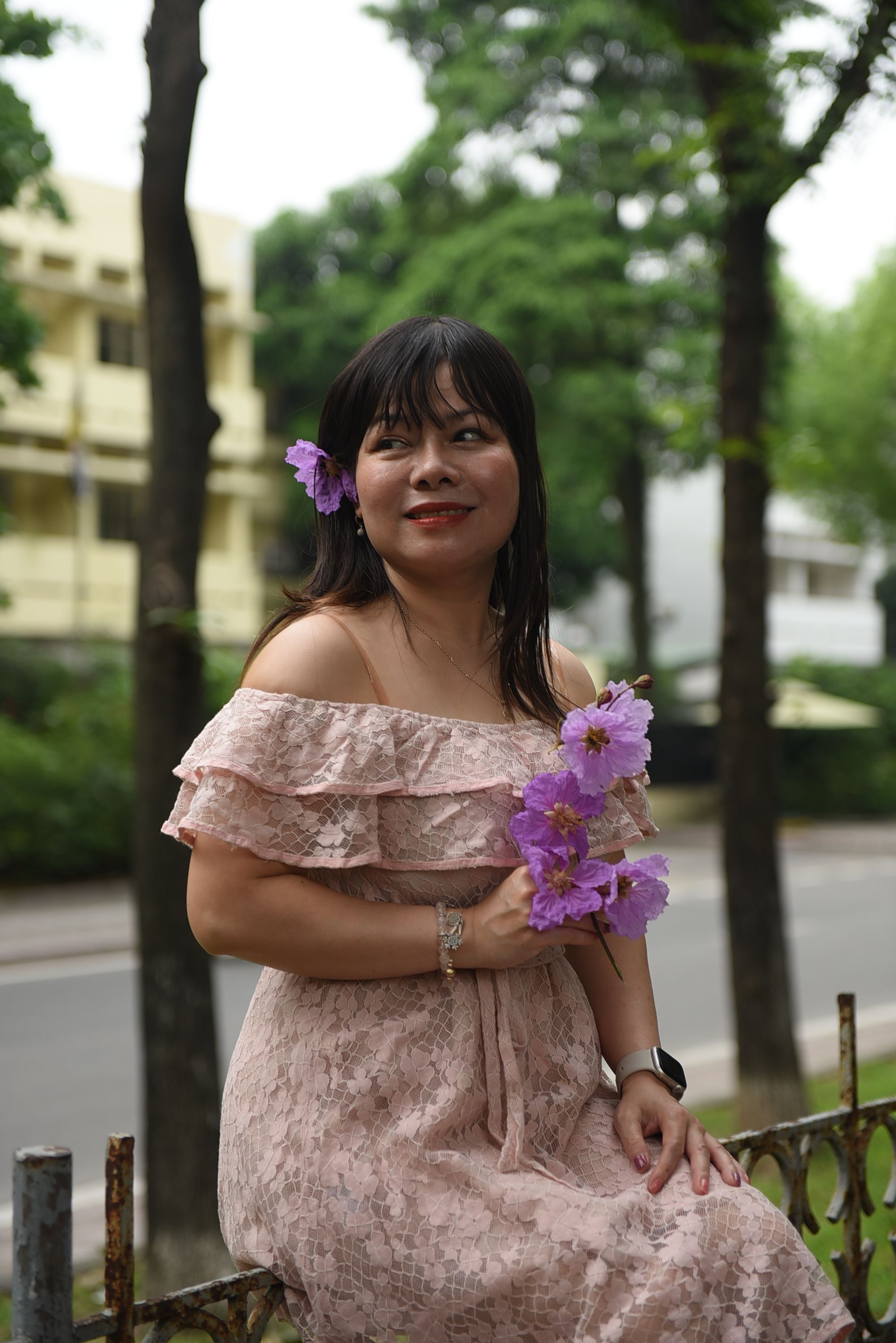 A woman in a pink dress holding a flower · Free Stock Photo