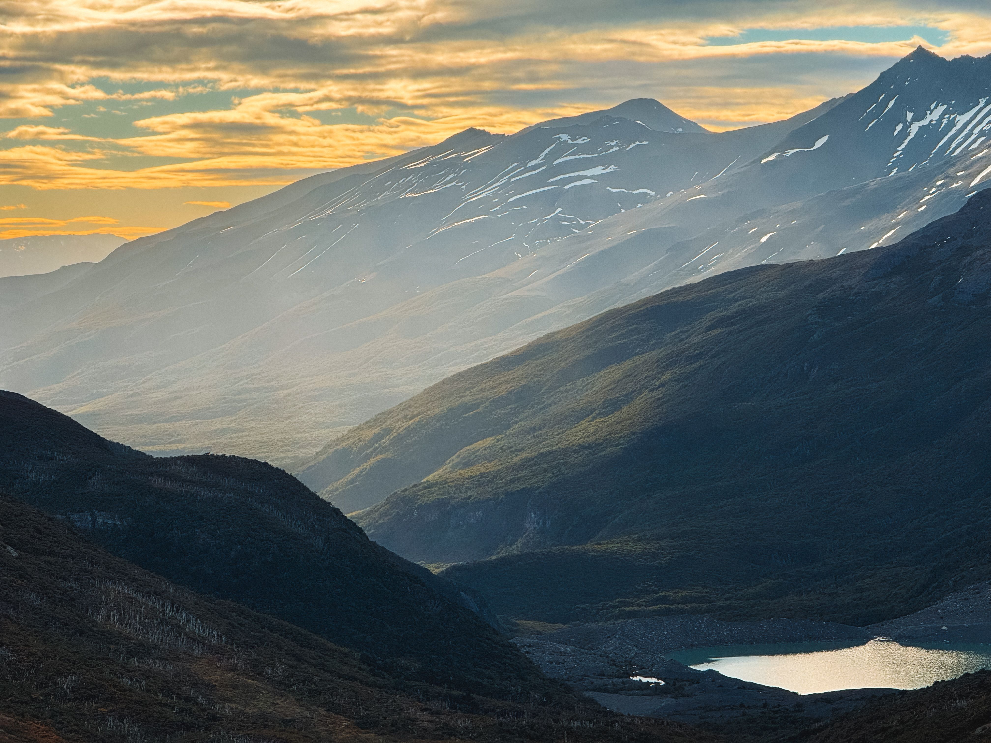 Breathtaking view of the rugged Patagonian mountains at sunset in Magallanes, Chile.