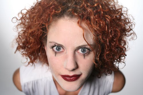 Close-up Photo of Woman Wearing White Top