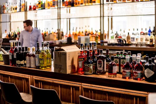 Free Man in Purple Shirt Standing Near the Counter Stock Photo