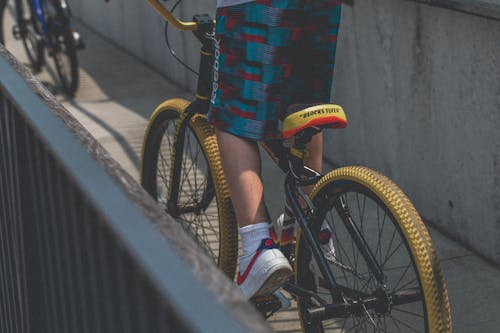 Free Person in Blue and Red Shorts Riding Bicycle Stock Photo