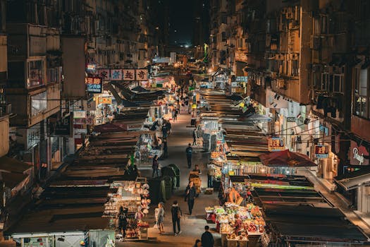 Explore the bustling night market in Mong Kok, Hong Kong, illuminated with vibrant street life.