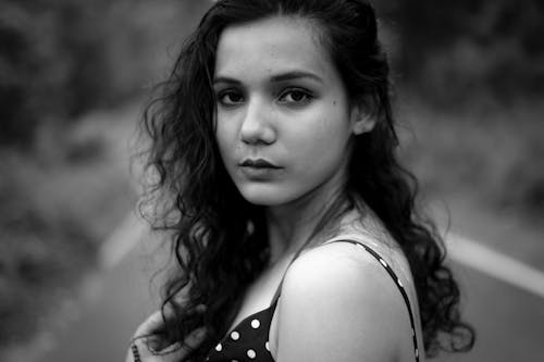 Black and White Portrait of a Young Woman with Curly Hair