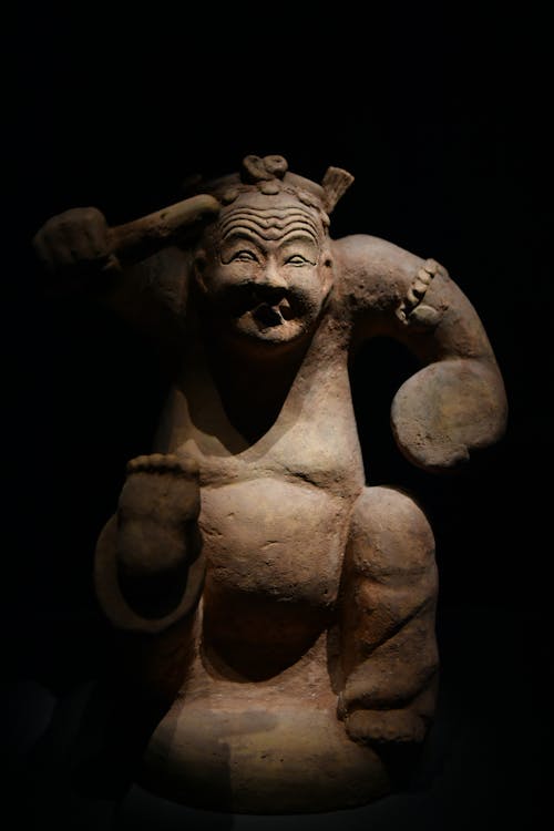 A clay figure of a man holding a sword