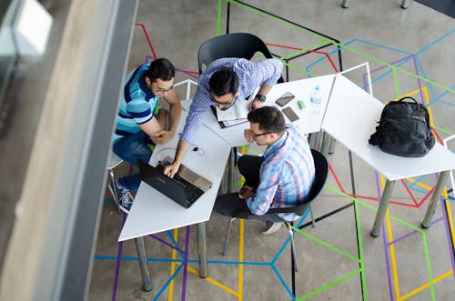 Top-view Photo of 3 Men in Front of Laptop