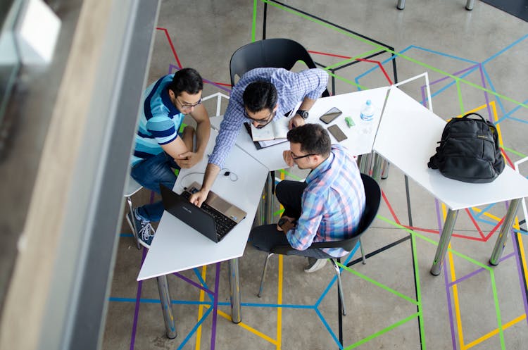 Top-view Photo Of 3 Men In Front Of Laptop