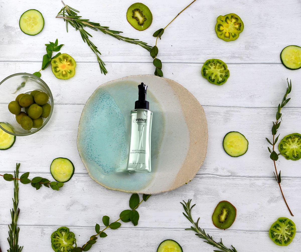 A serum bottle styled with botanicals