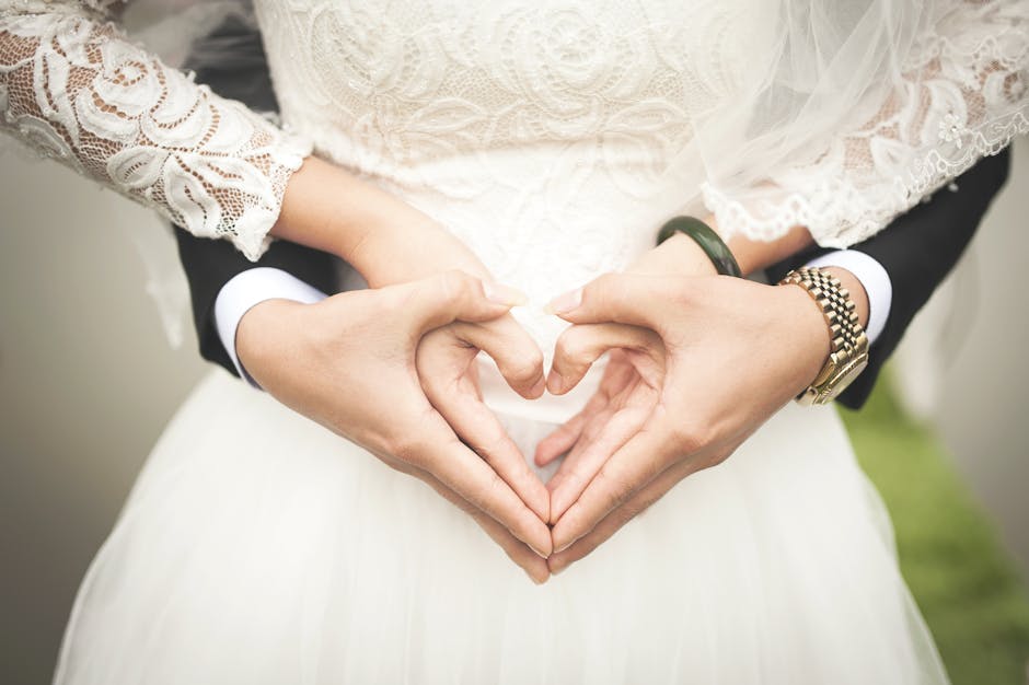 Midsection of Woman Making Heart Shape With Hands