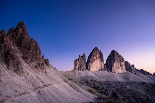 A stunning twilight scene showcasing Tre Cime di Lavaredo in the Dolomites, Italy's iconic mountain range.
