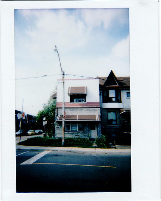 Vintage-style photo of a residential house with awnings in Toronto, Ontario, Canada.