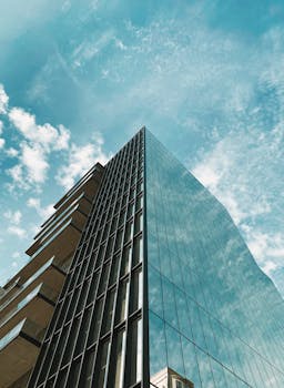 A sleek and modern glass high-rise building in downtown Santiago, Chile against a clear blue sky.