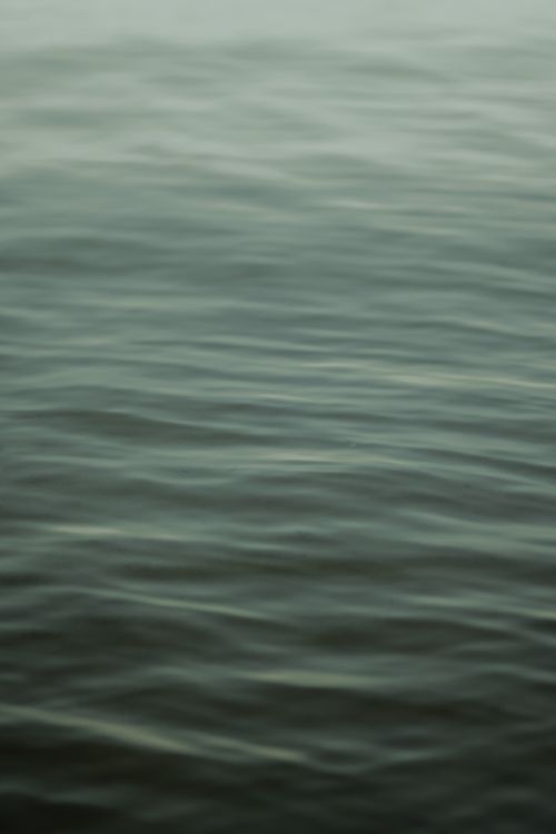 Free A serene view of a body of water with smooth ripples, providing a tranquil atmosphere. Stock Photo