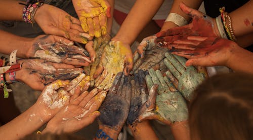 A group of people with their hands painted with paint