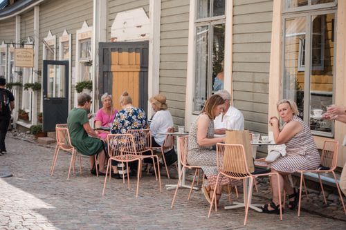 Free People enjoying a meal outdoors at a charming café in Porvoo, Finland. Stock Photo