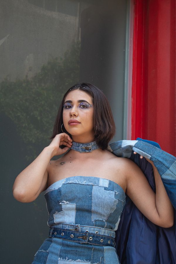 woman wearing denim jacket over mini dress