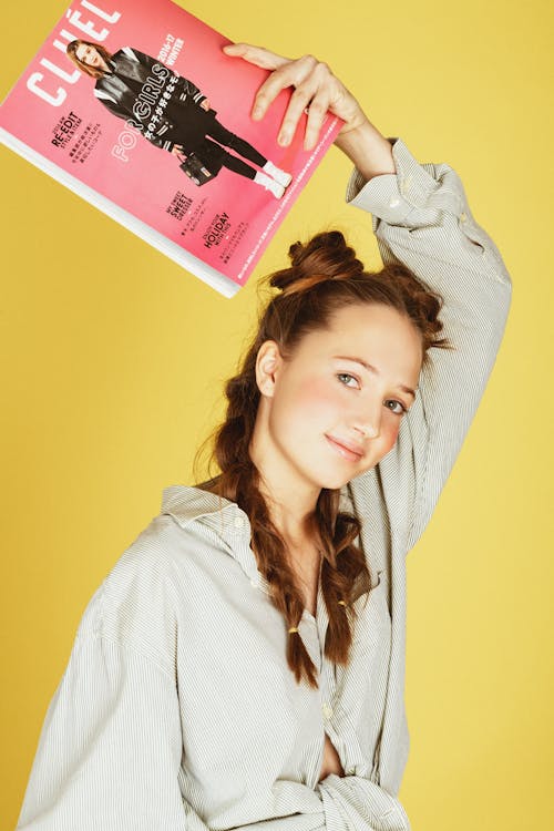 Photo of Woman Holding Magazine