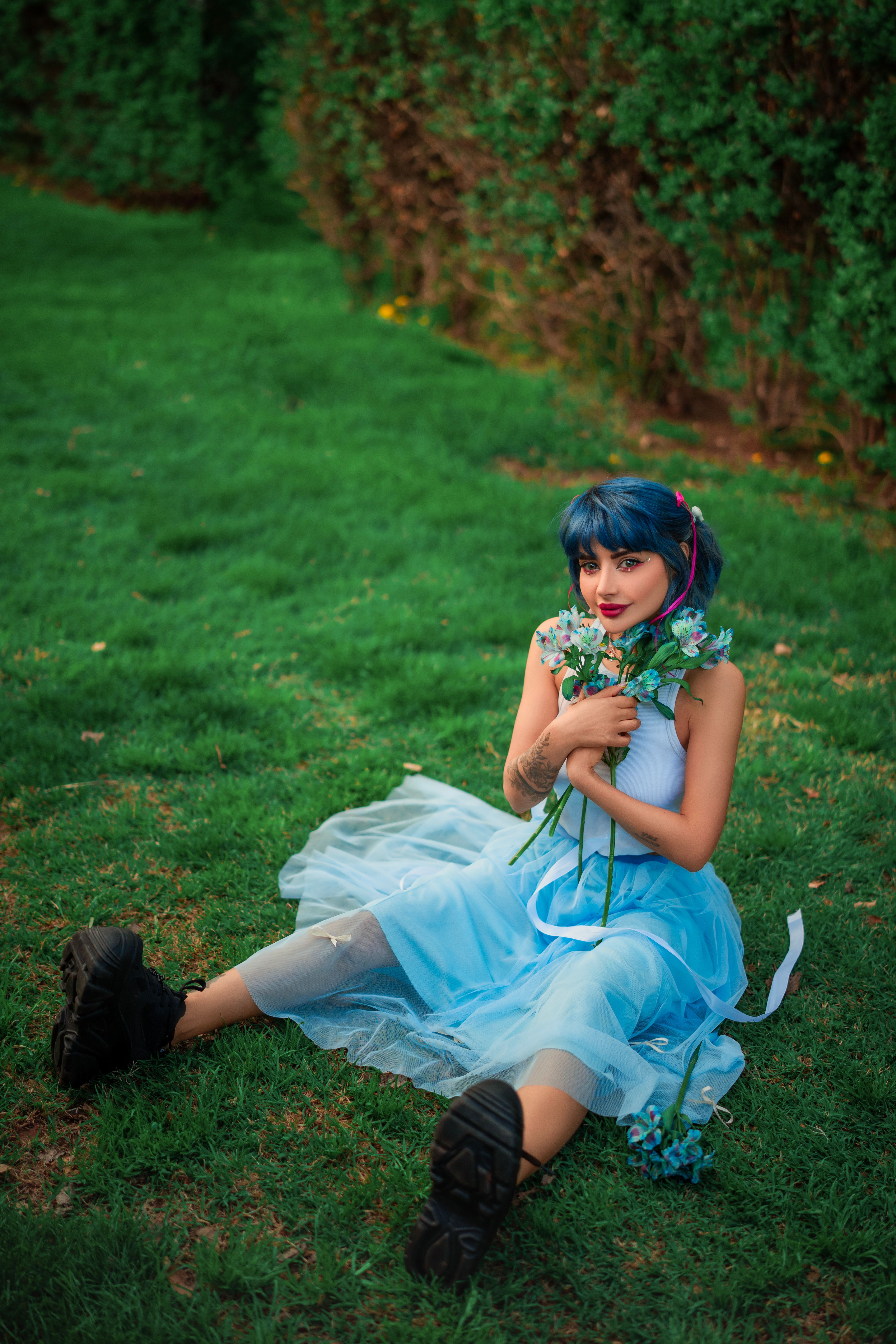 Woman Sitting in Blue Dress and with Flowers · Free Stock Photo