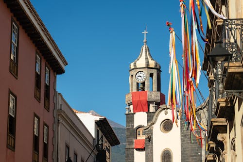 A church tower and a street with colorful flags