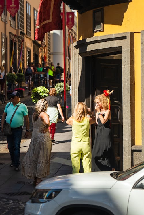 A woman is talking to a man in a yellow shirt