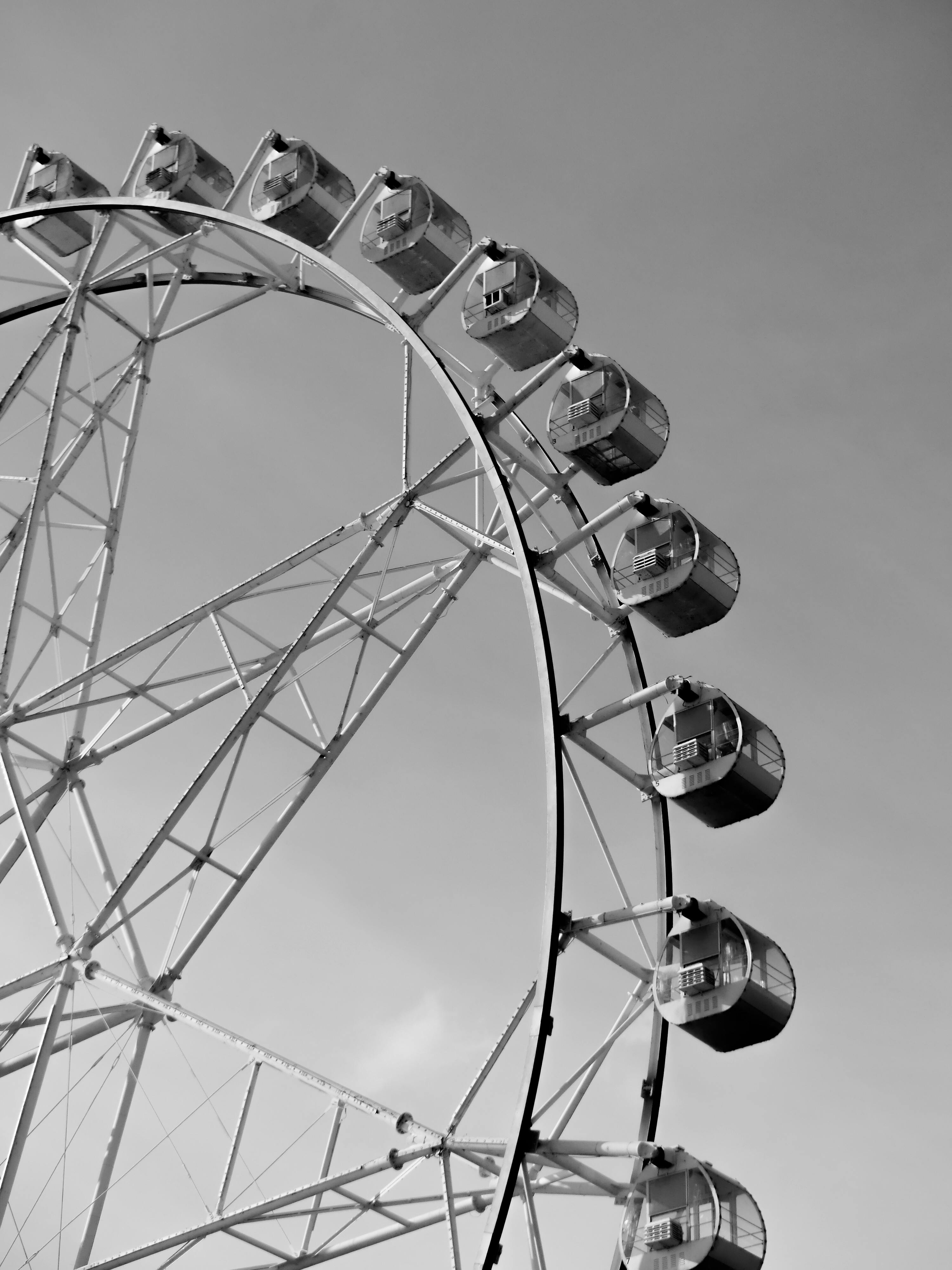 Monochrome view of a Ferris wheel against a clear sky in Manila, Philippines.