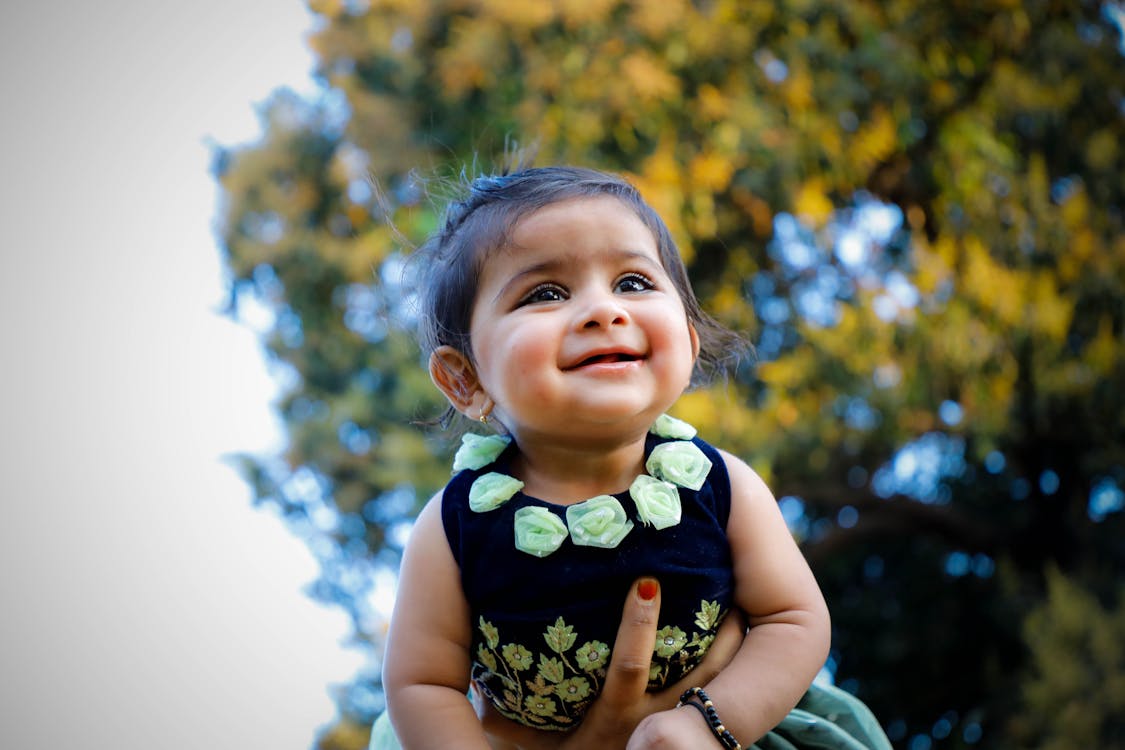Free Close-Up Photo of Baby Wearing Floral Dress Stock Photo