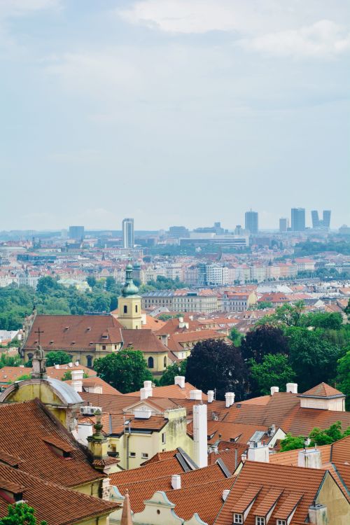 Free A beautiful aerial view of Prague showcasing historic red rooftops against a modern skyline. Stock Photo