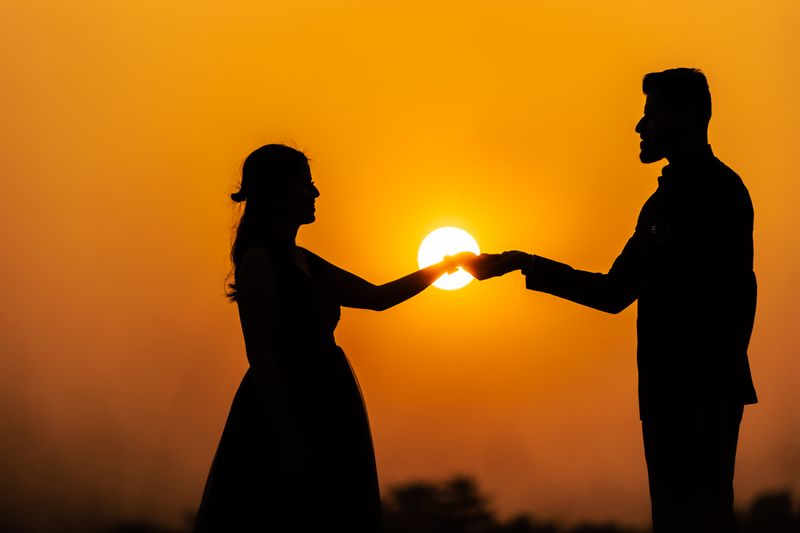 Omar and Salma holding hands at sunset