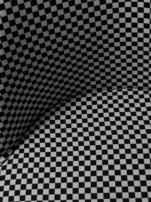 A black and white checkered pattern on a gray background