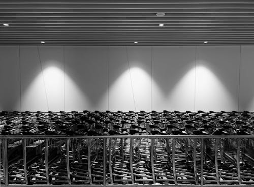 Black and white photo of rows of chairs in an airport