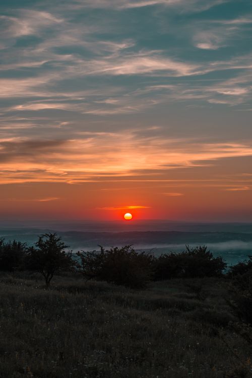 Free Beautiful sunset landscape with vibrant sky and peaceful nature scene. Stock Photo