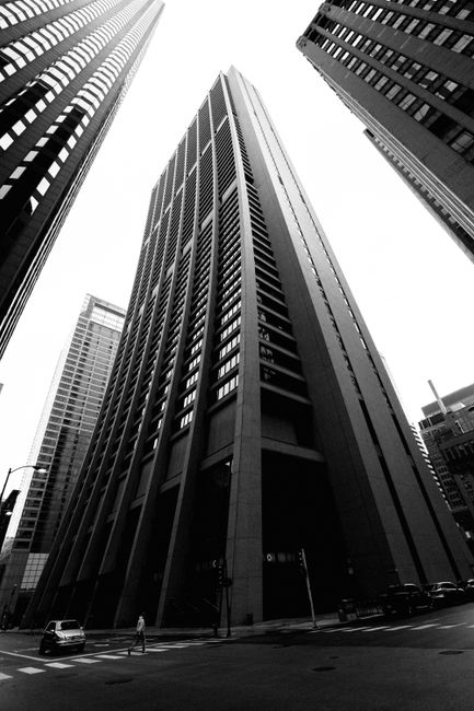 Black and white cityscape of towering skyscrapers in downtown Chicago.