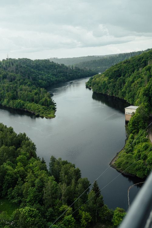 Free Drone shot of Rappbode Dam and lush greenery, reflecting tranquility and nature. Stock Photo