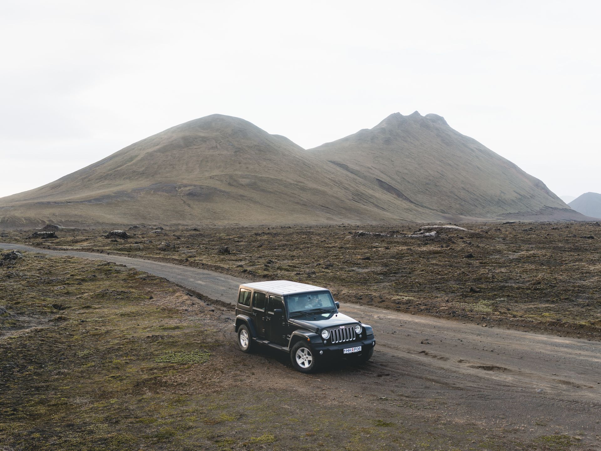 Explore the rugged beauty of Iceland with a 4x4 vehicle traversing remote gravel roads in the highlands.