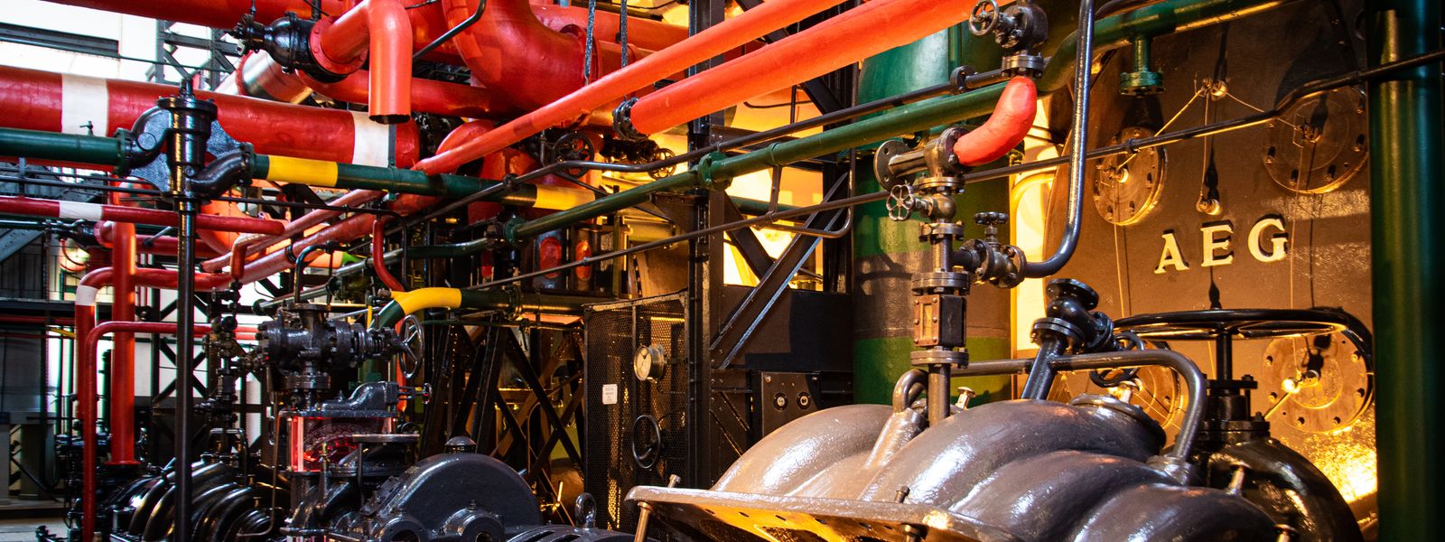 Industrial machinery with pipes and valves inside a plant