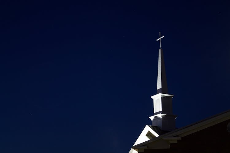 Low Angle View Of Cross Against Sky At Night