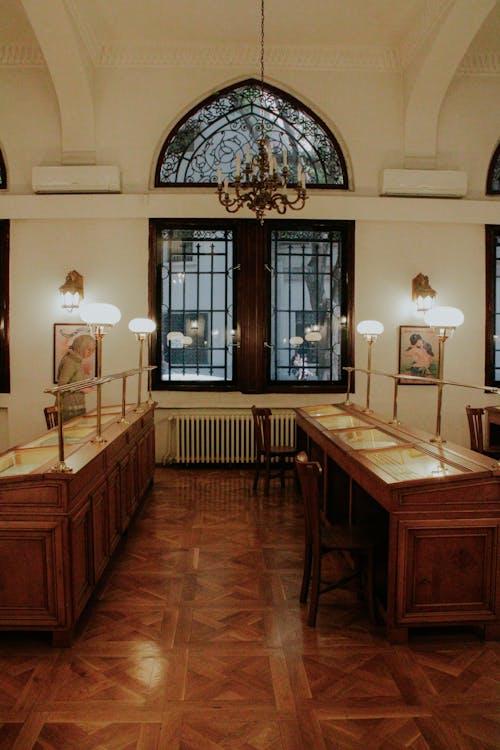 A room with a large table and two windows