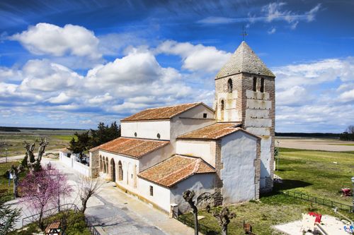 Free Beautiful church in Pinarejos, Spain against a vibrant cloudy sky. Perfect for travel and architecture enthusiasts. Stock Photo