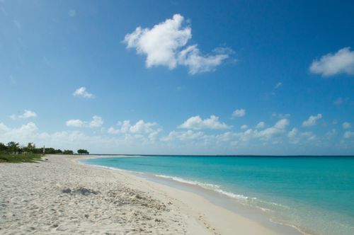 Free Pristine beach with turquoise waters and a clear sky in Gran Roque, Venezuela. Stock Photo