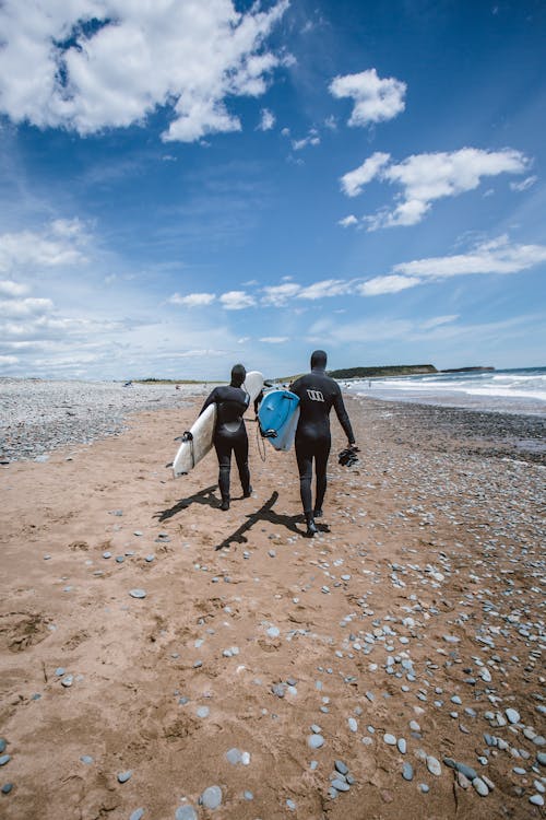 People Holding Surfboards