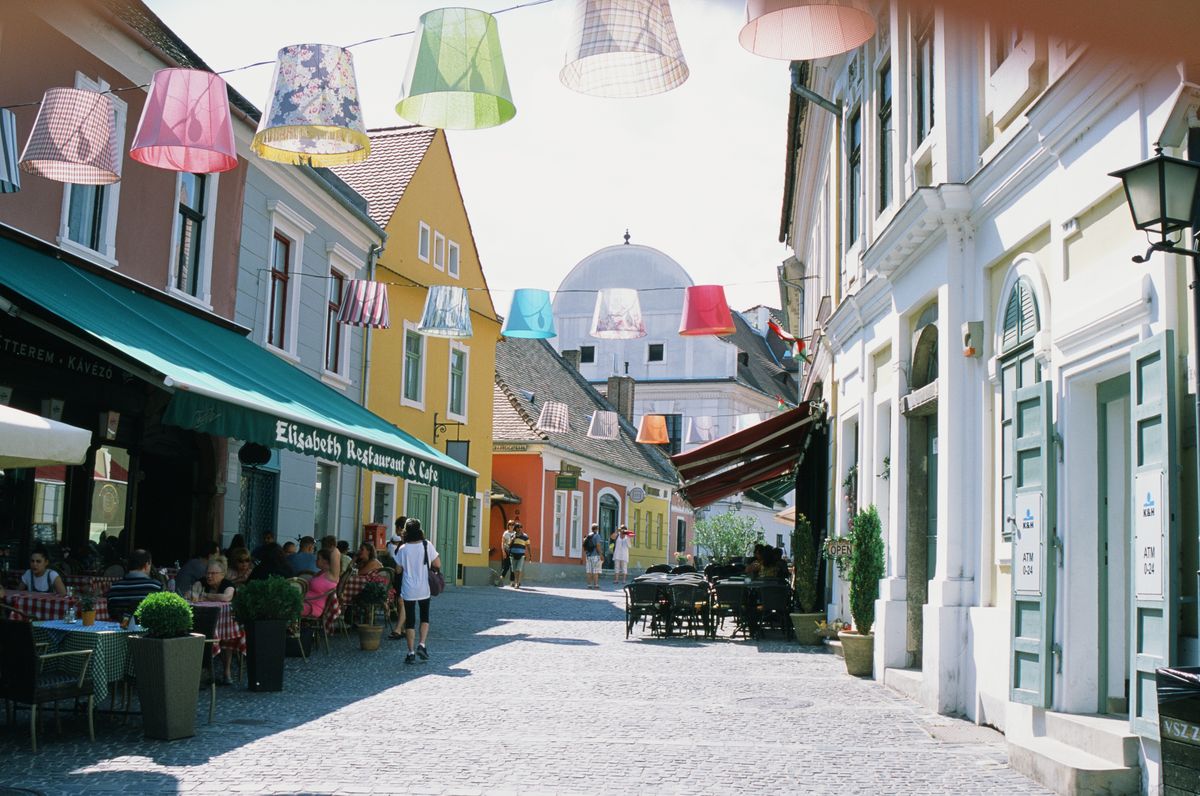 Colourful cobblestone lane with hanging lampshades in Szentendre