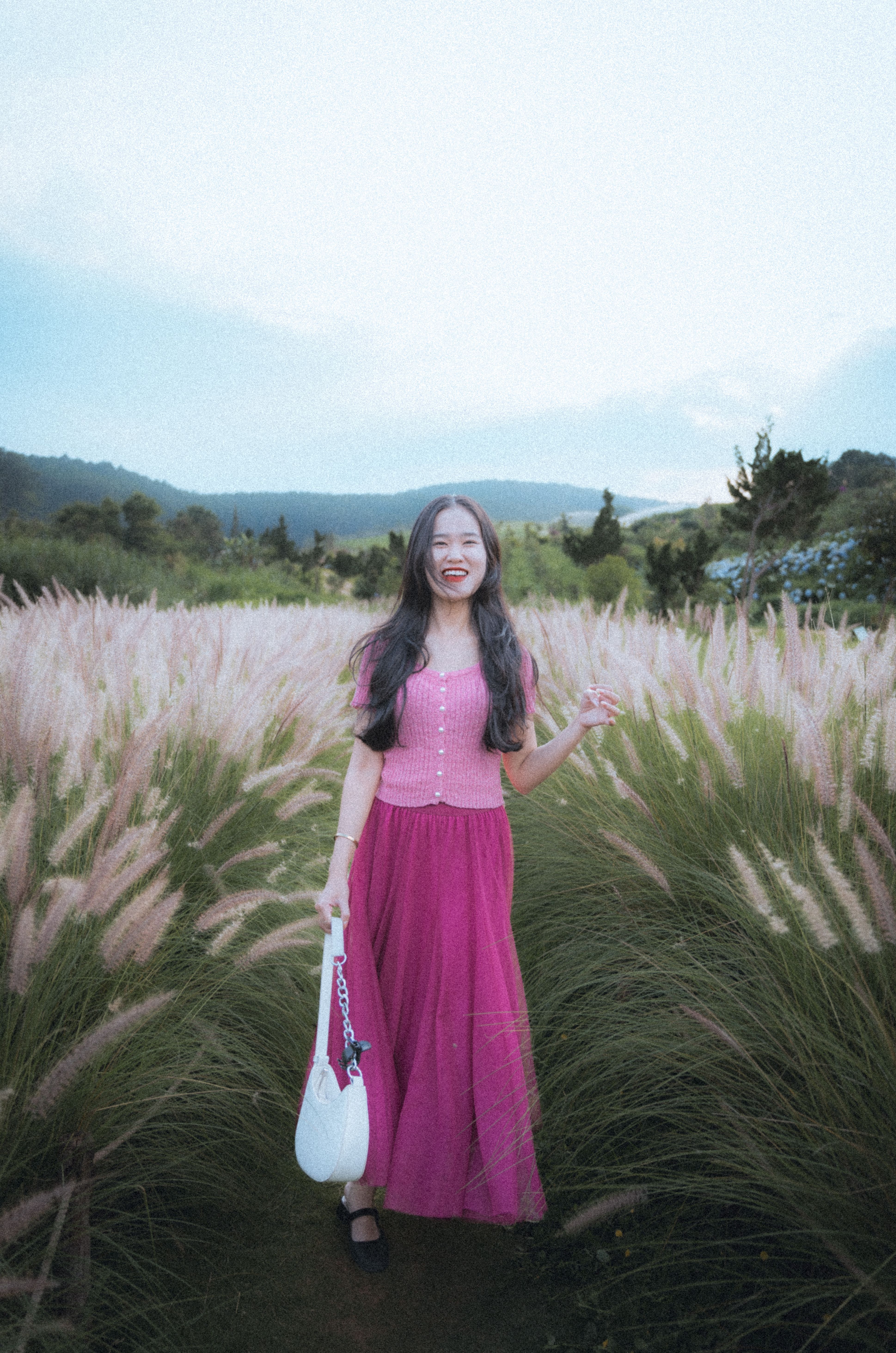 [ColoSach]-young-woman-in-a-pink-outfit-standing-in-a-pampas-grass-field-in-dalat,-vietnam.